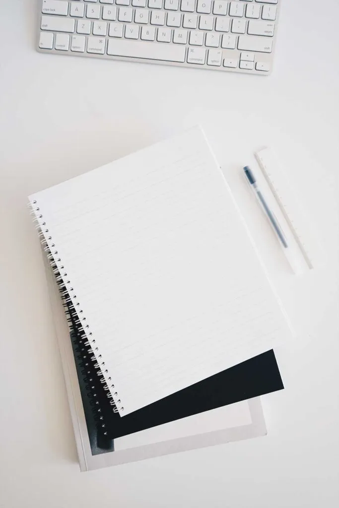 Notebooks, pen, and keyboard on the work desk